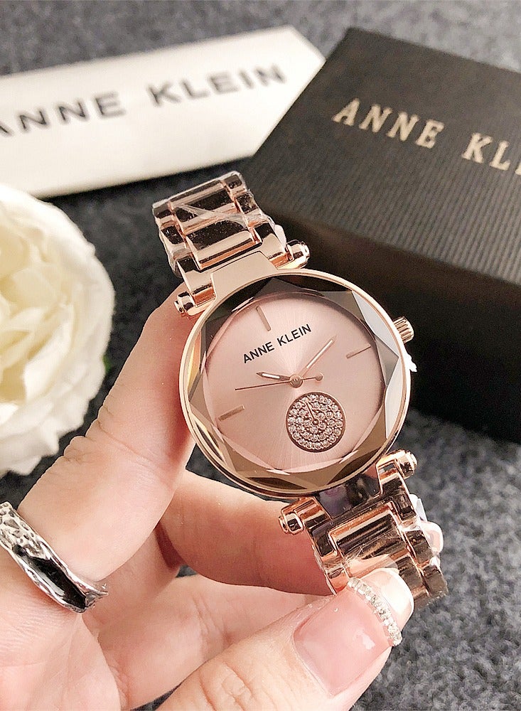 ساعة آن كلاين النسائية الدائرية كوارتز باللون الذهبي الوردي مع حزام من الفولاذ المقاوم للصدأ باللون الذهبي الوردي